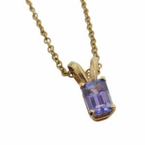 With a purple/blue hue, this 0.73 carat emerald cut tanzanite yellow gold pendant is something fun for the purple lovers!