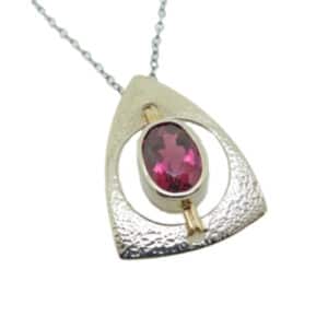 A custom designed pendant in 14 karat white and yellow gold. Showcasing a 2.344 carat oval shaped Rubellite Tourmaline. Created by our jeweler and owner, David Blitt as part of our Studio Tzela line. The perfect gift for October birthdays and 8th anniversaries.