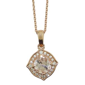 A vintage inspired 14 karat rose gold halo pendant. Showcasing a 0.90 carat Morganite. Surrounded by diamonds totaling 0.10 carats. The perfect gift for a subtle hint of colour, but still plenty of sparkle.