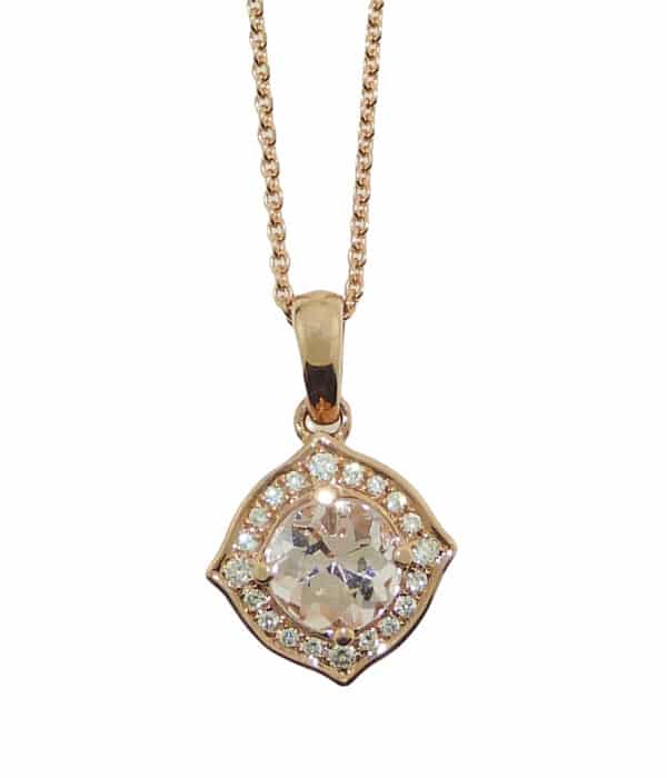 A vintage inspired 14 karat rose gold halo pendant. Showcasing a 0.90 carat Morganite. Surrounded by diamonds totaling 0.10 carats. The perfect gift for a subtle hint of colour, but still plenty of sparkle.