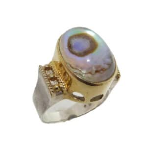 Sterling silver ring bezel set with a Paua quartz. This ring is accented with 22 karat yellow gold vermeil. This stunning ring is part of the Michou Collection.
