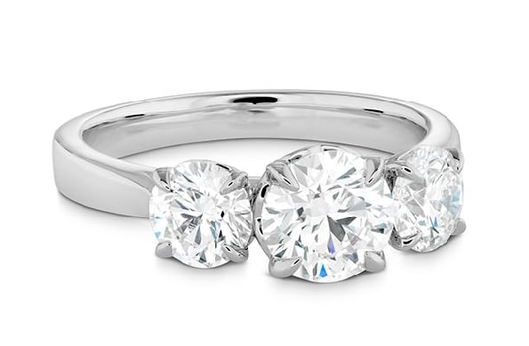 18K White gold Signature Classic 3 stone engagement ring by Hearts On Fire set with a 0.576ct I, VS2, and accented on the sides with 0.241ct and 0.240ct I, VS2, all ideal cut, round brilliant cut Hearts On Fire diamonds.