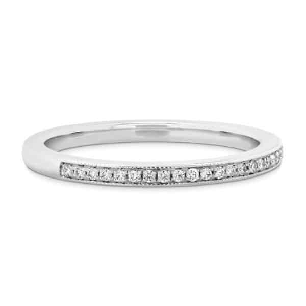 18 karat white gold 'Deco Chic' wedding band set with ideal cut, round brilliant cut diamonds by Hearts On Fire, 0.12 carat total weight, G/H, VS-SI. This ring features beautiful milgrain engraving.
