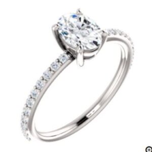 14K white gold solitaire engagement ring claw set with Charles & Colvard Forever One Created Colorless 5x7 Oval Moissanite and accented on the band with 22 claw set 1.3mm moissanites.
