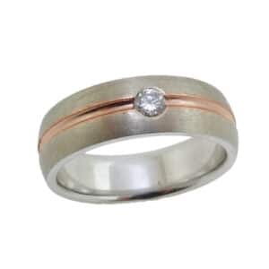 14K White and rose gold men's two tone band accented with a gypsy set 0.15 carat round brilliant cut diamond, SI1. This ring is available in 14K/18K white, yellow or rose gold and platinum with any combination of gemstones.