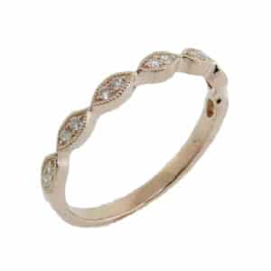 14 karat rose gold band set with 14 = 0.11ctw G/H/I, SI round brilliant cut diamonds. This stunning ring features milgrain engraving and is beautiful by itself or as part of a stack.