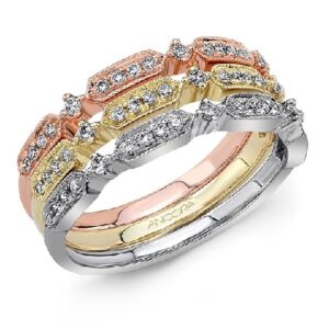 14 karat rose gold band set with 0.11ctw round brilliant cut diamonds. This stunning ring features milgrain engraving and is beautiful by itself or as part of a stack.