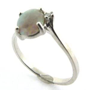14 karat white gold ring featuring a 0.61ct opal and is accented with a round brilliant cut diamond.