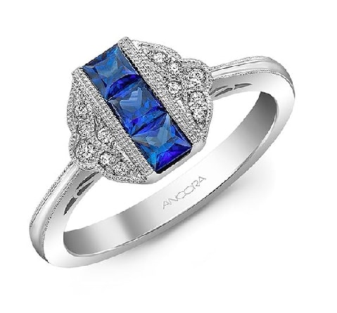 14 karat white gold ring set with 3 square cut sapphires and accented with a halo of diamonds.