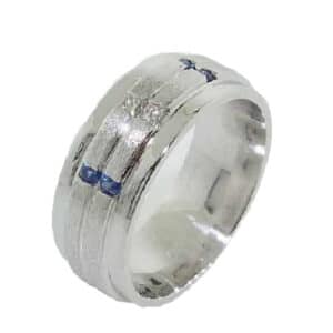 14K White gold custom men's band by Studio Tzela featuring 2 channel set princess cut diamonds, 0.09cttw, SI1, G/H, and 4 round brilliant cut blue sapphires, 0.168cttw. This ring is available in 14K/18K white, yellow or rose gold and platinum with any combination of gemstones.
