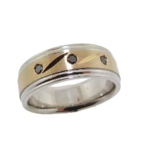 14K White and yellow gold men's band with detailed accents and 3 gypsy set round brilliant cut black diamonds, 0.09cttw. This ring is available in 14K/18K white, yellow or rose gold and platinum with any combination of gemstones.