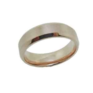 14 Karat rose gold 6.5mm beveled edge band with a stainless textured centre and polished edges. This ring is available in 14K/18K white, yellow or rose gold and platinum and in any width or finish.