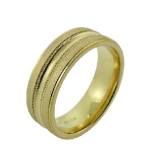 14 Karat yellow gold 7mm flat band with a concave centre, milgrain detailing and sandblast/polish texture. This ring is available in 14K/18K white, yellow or rose gold and platinum and in any width or finish.