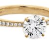 Signature 6 prong solitaire engagement ring with diamonds on the band by Hearts on Fire is available in 18 karat yellow and white gold as well as platinum