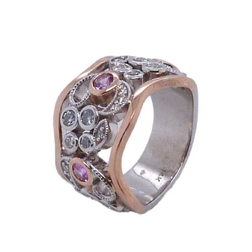 14 karat white and rose gold floral design ring set with 0.59ctw of pink sapphires and 24 = 0.678ctw F/G, VS-SI round brilliant cut diamonds. This stunning ring has milgrain engraving and is a custom design by David.