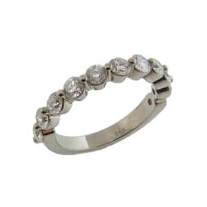 14 karat white gold band shared prong set with eleven, 1.20 total carat weight, G/H, VS-SI round brilliant cut diamonds.
