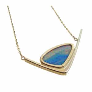 14 karat white and yellow gold pendant set with a Boulder opal doublet. This stunning pendant is a custom design by David.