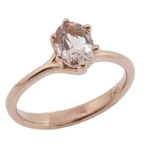 A 14 karat rose gold solitaire ring, showcasing a 0.76 carat round brilliant cut Morganite. This piece is perfect to represent January birthdays and 2nd anniversaries.