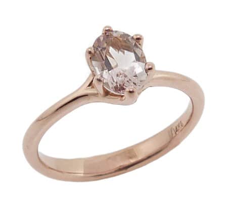 A 14 karat rose gold solitaire ring, showcasing a 0.76 carat round brilliant cut Morganite. This piece is perfect to represent January birthdays and 2nd anniversaries.