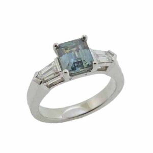 14K white gold ring set with a 1.476ct emerald cut green/blue Montana sapphire and accented with 2 bullet shape diamonds, 0.40ct, G, VS1.