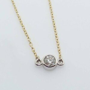 14k yellow gold 18" chain and pendant bezel set with a 0.175ct H/I, I1 round brilliant cut diamond.