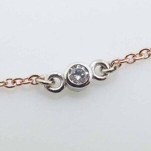 14k rose gold 18" chain and pendant bezel set with a 0.03ct H/I, I1 round brilliant cut diamond.