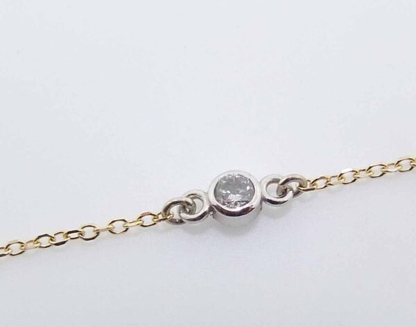 14k yellow gold 18" chain and pendant bezel set with a 0.065ct H/I, I1 round brilliant cut diamond.