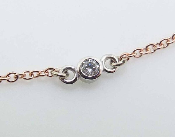 14k rose gold 18" chain and pendant bezel set with a 0.065ct H/I, I1 round brilliant cut diamond.