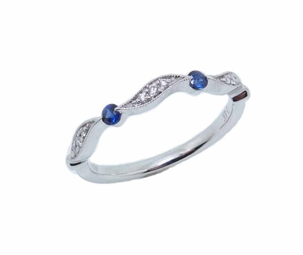 14 karat white gold band set with 9 = 0.05cttw round brilliant cut diamonds and 2 = 0.11cttw sapphires.  Wear this band alone or stack it with other bands.  Sapphire is the birthstone for September.