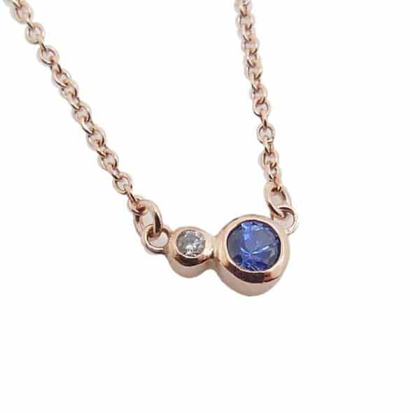 14K rose gold pendant bezel set with a 0.12ct Sapphire and a 0.0.014ct G/H, I1 round brilliant cut diamond.  This pendant comes with a 14k rose gold 18" chain.  Sapphire is the birthstone for September.