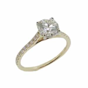 14K White and yellow gold solitaire engagement ring set with an ideal cut, round brilliant cut Hearts On Fire diamond, 1.051ct, J, VS2 and accented with 26 claw set round brilliant cut diamonds, 0.28cttw diamonds, G/H, SI.