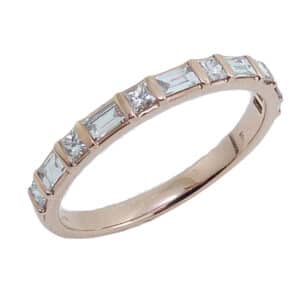 Diamond Lady's band in 14K Rose gold and set with 6 princess cut and 5 baguettes, totaling 0.50 carats, H-I, VS.