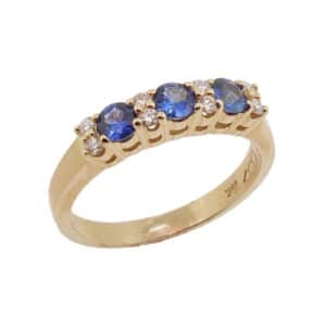 14k yellow gold ring featuring 3 blue sapphires, 0.44 total carat weight, and 8 round brilliant cut diamonds, 0.13 total carat weight.  Sapphire is the birthstone for September.