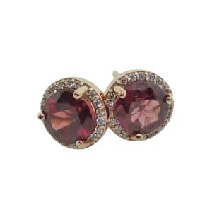14k rose gold halo stud earrings set with 2 = 2.14cttw rhodolite garnets and accented with 0.10cttw G/H, I1 round brilliant cut diamonds.
