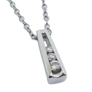 14k white gold tapered bar pendant set with 3 = 0.175cttw round brilliant cut diamonds.