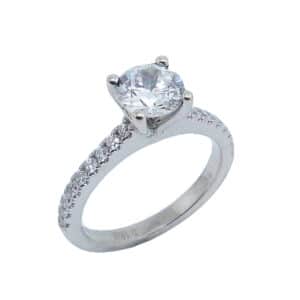 14 karat white gold solitaire engagement ring set in the centre with a 1.0ct CZ and featuring 0.25ctw G/H, VS-SI round brilliant cut diamonds down the band. This unique design is a great alternative to a traditional solitaire ring. Priced without a center gemstone. Let us find you the perfect center that fits your tastes and budget!
