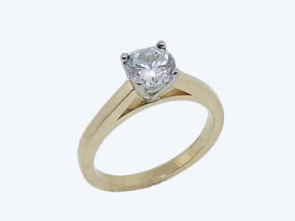 18K yellow and white gold solitaire engagement ring. Priced without a center gemstone. Let us find you the perfect center that fits your tastes and budget!