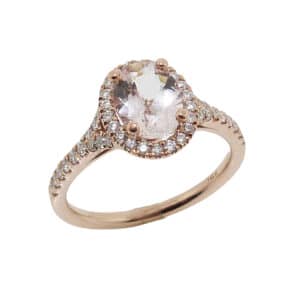 14k rose gold split-shank halo ring featuring a 0.96ct oval cut Morganite and accented with 46 = 0.38cttw round brilliant cut diamonds.