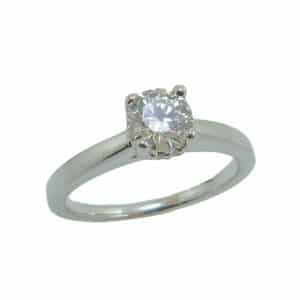14 karat white gold solitaire engagement ring with a 4 prong head featuring a 0.57ct, I, VS2 round brilliant cut diamond by Hearts on Fire.  This solitaire also features a hidden halo with 0.50cttw G/H, SI1 round brilliant cut diamonds.