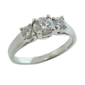 14K White gold three stone engagement ring claw set with 0.34 carat H, I1 excellent cut, round brilliant cut diamond and two I, SI2 excellent cut, round brilliant cut diamonds totaling 0.282 carats.