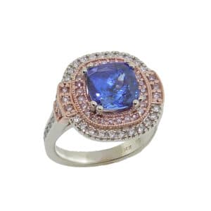 14K white and rose gold ring featuring a stunning 2.32ct Tanzanite and accented with a halo of 42 = 0.29cttw pink round brilliant cut diamonds and 37 = 0.317cttw F/G, VS-SI round brilliant cut diamonds. Tanzanite is the birthstone for December.