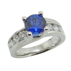 14 karat white gold ring featuring a 1.32ct sapphire accented by 10 = 0.90ct G/H, VS2-SI, round brilliant cut diamonds. Sapphire is the birthstone for September.