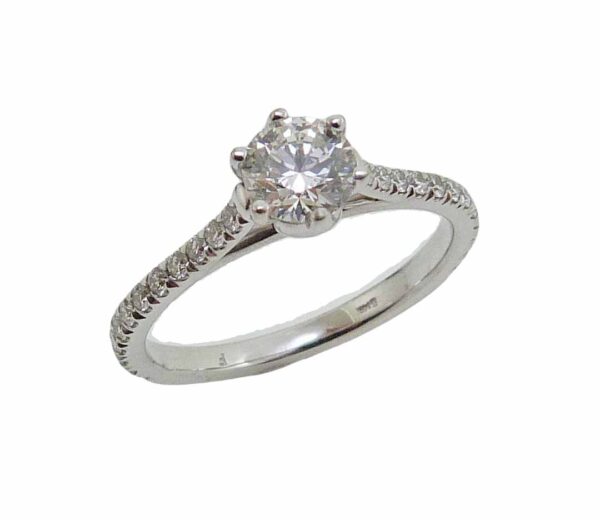 14K White gold 6 prong engagement ring claw set with 0.502 carat, I, SI2 ideal cut, round brilliant cut diamond by Hearts On Fire in the centre and accented on the band with 24 french-set round brilliant cut diamonds totaling 0.33 carat.