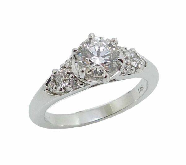 14K White gold "Queen Elizabeth" style engagement ring set with an ideal cut Hearts On Fire diamond, 0.752 carat, F, VS2 and accented on the sides with 8 excellent cut, round brilliant cut diamonds, 0.25cttw, F/G, SI1.
