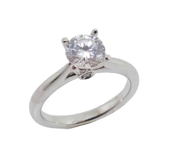 14K white gold solitaire mount claw set with a 0.75 carat CZ center accented on the profile with 2 bezel set round brilliant cut diamonds, 0.02-0.03cttw, I, VS. Priced without a center gemstone. Let us find you the perfect center that fits your tastes and budget!