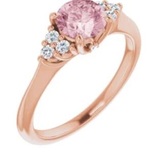 14K rose gold ring set with a 0.79ct round Morganite and 6 = 0.20cttw H, SI1-2, very good cut round brilliant cut diamonds.