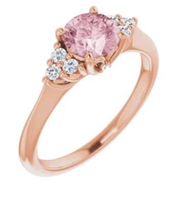 14K rose gold ring set with a 0.79ct round Morganite and 6 = 0.20cttw H, SI1-2, very good cut round brilliant cut diamonds.