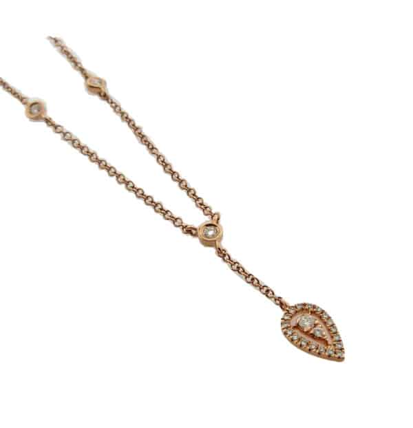 14K rose gold diamond necklace with 20 diamonds set into a drop pear shape halo and 3 bezel set diamonds, total carat weight, 0.15, GHI, S1.