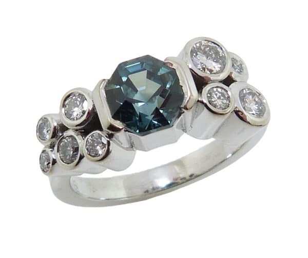 14K White gold Studio Tzela custom lady's ring semi bezel set with one 1.41 carat blue/green octagonal natural sapphire, GIA graded and 9 bezel set, very good-excellent, round brilliant cut diamonds, 0.47 total carat weight, F/G, VS1-2.
