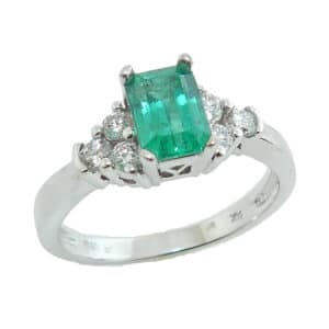 14 karat white gold ring set with a 0.75ct Emerald accented by 6 = 0.22ctw round brilliant cut diamonds.